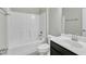 Bright bathroom features white tub/shower, modern fixtures and dark wood cabinets with a sleek, stylish design at 1844 Austin Ridge Pkwy, Wake Forest, NC 27587