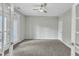 A spacious bedroom with ample natural light and a ceiling fan at 1844 Austin Ridge Pkwy, Wake Forest, NC 27587