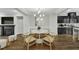 Open concept dining room features hardwood floors, modern chandelier, fireplace, and connects to kitchen at 1844 Austin Ridge Pkwy, Wake Forest, NC 27587