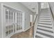 A bright entryway with french doors and access to a staircase at 1844 Austin Ridge Pkwy, Wake Forest, NC 27587