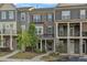 A charming townhouse with brick and siding, complemented by a well-manicured lawn at 1844 Austin Ridge Pkwy, Wake Forest, NC 27587