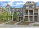 A charming townhouse with brick and siding, complemented by a well-manicured lawn at 1844 Austin Ridge Pkwy, Wake Forest, NC 27587