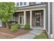 A front porch with brick columns and a well manicured lawn at 1844 Austin Ridge Pkwy, Wake Forest, NC 27587