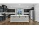 Spacious kitchen features black cabinets, stainless steel appliances, quartz countertops, and a kitchen island at 1844 Austin Ridge Pkwy, Wake Forest, NC 27587