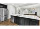 Modern kitchen featuring black cabinets, stainless steel appliances, quartz countertops, and kitchen island with sink at 1844 Austin Ridge Pkwy, Wake Forest, NC 27587