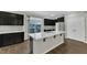 Well-lit kitchen featuring black cabinets, white subway tile backsplash, stainless appliances, and quartz countertops at 1844 Austin Ridge Pkwy, Wake Forest, NC 27587