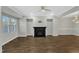 The light-filled living room with hardwood floors is highlighted by a black fireplace at 1844 Austin Ridge Pkwy, Wake Forest, NC 27587