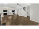 Open-concept living room featuring hardwood floors seamlessly connects the kitchen and staircase at 1844 Austin Ridge Pkwy, Wake Forest, NC 27587