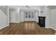 Bright living room features hardwood floors, a ceiling fan, fireplace and natural light at 1844 Austin Ridge Pkwy, Wake Forest, NC 27587