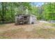 Backyard features new wooden deck and stairs, and lush greenery at 1903 Meadowbrook St, Sanford, NC 27330