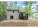 View of the backyard, deck with stairs, and exterior of the house with mature trees at 1903 Meadowbrook St, Sanford, NC 27330