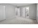 Spacious bedroom with neutral carpet, features a double door closet and ensuite bathroom at 1903 Meadowbrook St, Sanford, NC 27330