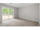 Bright bedroom with a sliding glass door that allows you to access backyard at 1903 Meadowbrook St, Sanford, NC 27330