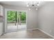 Dining room with modern chandelier and sliding glass doors to the backyard deck at 1903 Meadowbrook St, Sanford, NC 27330