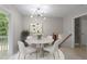 Dining area with modern light fixture, table, and sliding door leading to patio at 1903 Meadowbrook St, Sanford, NC 27330