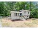 Charming two-story home with blue front door, white brick, new landscaping and front stairs at 1903 Meadowbrook St, Sanford, NC 27330
