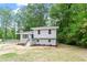 Charming two-story home with new landscaping and staircase, surrounded by mature trees at 1903 Meadowbrook St, Sanford, NC 27330