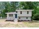 Charming two-story home with light-colored exterior, blue front door, and well-maintained landscaping at 1903 Meadowbrook St, Sanford, NC 27330