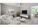Open-concept living room with modern furniture and a view into the dining area at 1903 Meadowbrook St, Sanford, NC 27330