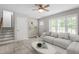 Bright living room with hardwood floors, ceiling fan, and a comfortable couch at 1903 Meadowbrook St, Sanford, NC 27330