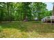 A verdant backyard with mature trees and green grass creating a serene outdoor space at 1915 Redding Ln, Durham, NC 27712