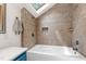 Stylish bathroom with tiled walls, bathtub and skylight at 1915 Redding Ln, Durham, NC 27712