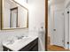 Bathroom featuring vanity and mirror with hall access at 1915 Redding Ln, Durham, NC 27712