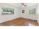 Bright bedroom with hardwood floors, ceiling fan, and two windows offering natural light at 1915 Redding Ln, Durham, NC 27712