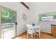 Bright dining area featuring a round table, white chairs, and a view of the outdoors at 1915 Redding Ln, Durham, NC 27712