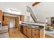 Open kitchen with wood cabinets, stainless steel appliances, and view to the living room at 1915 Redding Ln, Durham, NC 27712