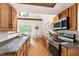 Modern kitchen features wood cabinets, updated appliances, and a view into the dining area at 1915 Redding Ln, Durham, NC 27712