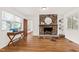 Bright living room featuring a stone fireplace and hardwood flooring at 1915 Redding Ln, Durham, NC 27712