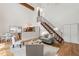 Bright living room with high ceilings, wooden beams, hardwood floors, and an open staircase at 1915 Redding Ln, Durham, NC 27712