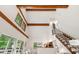 Open-concept living space featuring high ceilings, exposed beams, and large windows for ample natural light at 1915 Redding Ln, Durham, NC 27712