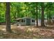 View of an outdoor storage shed surrounded by trees at 1915 Redding Ln, Durham, NC 27712
