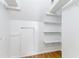 Walk-in closet featuring shelving and a small door for access at 1915 Redding Ln, Durham, NC 27712