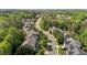 Beautiful aerial view of a neighborhood with lush green trees surrounding well-maintained homes at 1928 Grace Point Rd, Morrisville, NC 27560