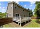 Exterior angle: Backyard with multilevel deck, lawn and wood privacy fence at 1928 Grace Point Rd, Morrisville, NC 27560