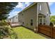 Exterior ground view: Wood fence creates a natural backyard border with a mature flower bush at 1928 Grace Point Rd, Morrisville, NC 27560