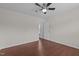 Bedroom with open doorway features hardwood floors and a ceiling fan at 1928 Grace Point Rd, Morrisville, NC 27560