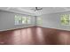 Primary bedroom features hardwood floors, natural light from large windows and tray ceiling at 1928 Grace Point Rd, Morrisville, NC 27560