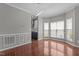 Bright dining area features hardwood floors, wainscotting, and multiple windows with a modern lighting fixture at 1928 Grace Point Rd, Morrisville, NC 27560