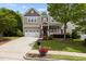 Charming two-story home featuring a manicured lawn, two car garage, and inviting front porch at 1928 Grace Point Rd, Morrisville, NC 27560