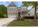 Charming home with a well-manicured front yard and a cozy porch with white railings at 1928 Grace Point Rd, Morrisville, NC 27560