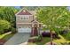 Charming two-story home with a welcoming front porch, well-manicured lawn, and an attached garage offering curb appeal at 1928 Grace Point Rd, Morrisville, NC 27560