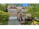 Charming two-story home with a welcoming front porch, well-manicured lawn, and an attached garage offering curb appeal at 1928 Grace Point Rd, Morrisville, NC 27560