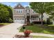 Charming two-story home featuring a manicured lawn, two car garage, and inviting front porch at 1928 Grace Point Rd, Morrisville, NC 27560