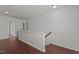 Upstairs hallway featuring hardwood floors and two doors leading to the rooms at 1928 Grace Point Rd, Morrisville, NC 27560