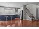 Bright kitchen with stainless steel appliances, center island, and stairs leading to the next level at 1928 Grace Point Rd, Morrisville, NC 27560
