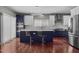 Modern kitchen featuring stainless appliances, two-tone cabinetry, and a large island with bar seating at 1928 Grace Point Rd, Morrisville, NC 27560